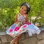 Face, Smile, Leg, Dress, Human Body, Baby & Toddler Clothing, Plant, Pink, Happy, Grass, Day Dress, People In Nature, Fun, Toddler, Leisure, Thigh, Sandal, Child, Magenta, Embellishment, Person, Joy