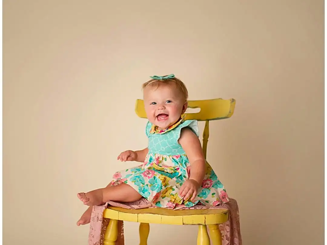 Face, Furniture, Leg, Chair, Dress, Baby & Toddler Clothing, Neck, Sleeve, Baby, Magenta, T-shirt, Toddler, Wood, Happy, Sitting, Peach, Room, Shorts, Visual Arts, Child, Person