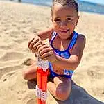 Smile, Photograph, Water, Beach, Happy, Travel, Body Of Water, Fun, Thigh, Sky, People On Beach, Toddler, Summer, People In Nature, Child, Recreation, Human Leg, Electric Blue, Sand, Plastic Bottle, Person, Joy