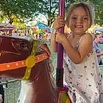 Smile, Photograph, Tree, Yellow, Pink, Fun, Playground, Leisure, Happy, Summer, Toddler, Recreation, City, Outdoor Play Equipment, Pole, Working Animal, Baby & Toddler Clothing, Human Settlement, Event, Horse Tack, Person, Joy