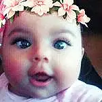 Face, Pink, Eyebrow, Skin, Flower, Cheek, Hair Accessory, Nose, Child, Infant, Head, Forehead, Eyes, Headpiece, Lip, Girl, Smile, Ear, Petal, Headband, Person