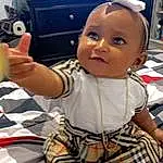 Cheek, Skin, Hairstyle, Photograph, White, Baby, Yellow, Finger, Cool, Fun, Toddler, Baby & Toddler Clothing, Child, Toy, Happy, Thumb, Gadget, T-shirt, Person