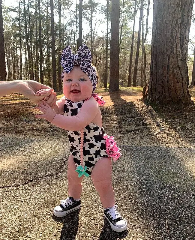 Smile, Tree, Plant, Baby & Toddler Clothing, Happy, Grass, Toddler, People In Nature, Eyewear, Asphalt, Fun, Recreation, Child, Cap, Fashion Accessory, Pattern, Headpiece, Leisure, Play, Magenta, Person, Headwear