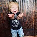 Clothing, Face, Hair, Jeans, Skin, Smile, Chin, Hand, Arm, Eyes, Leg, Flash Photography, Sleeve, Wood, Happy, Baby & Toddler Clothing, Iris, Denim, Toddler, Cool, Person