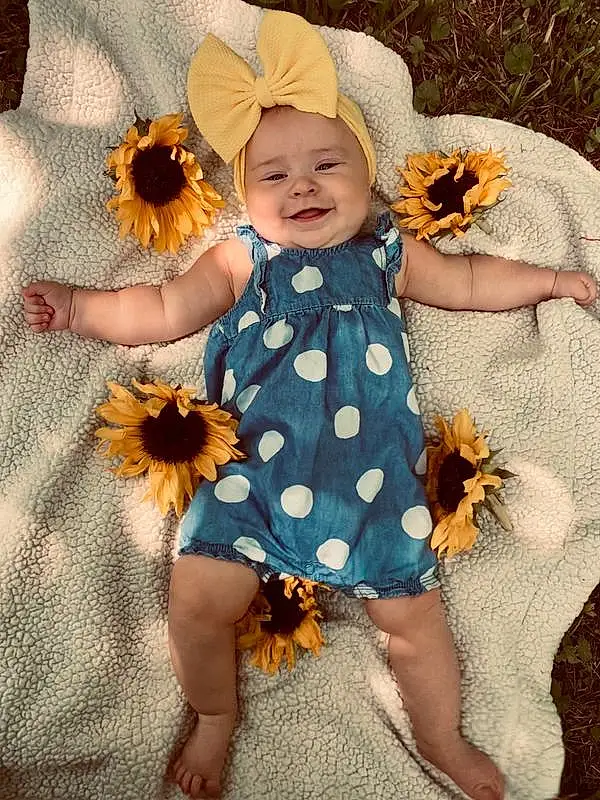 Flower, Skin, Plant, Photograph, Smile, Petal, Leaf, Baby & Toddler Clothing, Dress, Textile, Yellow, Happy, Pink, Toddler, Baby, Pattern, Day Dress, Child, Beauty, Peach, Person, Joy, Headwear