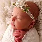 Skin, Head, Lip, Arm, Dress, Plant, White, Flower, Cap, Textile, Baby & Toddler Clothing, Petal, Pink, Headgear, Tiara, Nail, Headpiece, Baby, Headband, Toddler