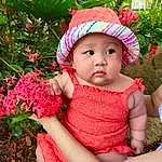 Skin, Lip, Plant, Eyes, Facial Expression, People In Nature, Green, Baby & Toddler Clothing, Botany, Happy, Pink, Grass, Hat, Sun Hat, Cap, Toddler, Magenta, Baby, Thigh, Child, Person, Headwear