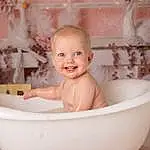 Cheek, Skin, Smile, Baby Bathing, Bathtub, Eyes, White, Fluid, Bathing, Bathroom, Water, Pink, Happy, Fun, Toddler, People, Baby, Child, Plumbing Fixture, Person, Joy