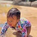 Face, Hair, Water, Skin, Head, Eyes, Smile, Body Of Water, Happy, People On Beach, Yellow, Toddler, Leisure, Sand, Summer, Bathing, Recreation, Child, Soil, People In Nature, Person