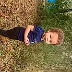 Plant, People In Nature, Wood, Sunlight, Grass, Woody Plant, Tree, Happy, Toddler, Grassland, Electric Blue, Landscape, Wilderness, Soil, Fun, Leisure, Sitting, Natural Landscape, Forest, Person