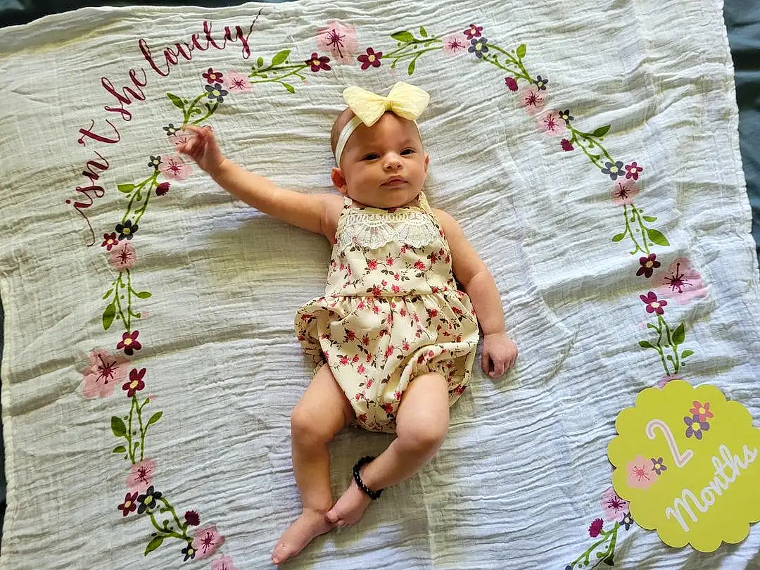 Skin, Plant, Hand, White, Flower, Botany, Petal, Leaf, Dress, Textile, Happy, Baby & Toddler Clothing, Pink, Baby, Grass, Toddler, Summer, Pattern, Beauty, Person