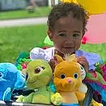 Photograph, Smile, Green, Yellow, Toy, Happy, Grass, Fun, Public Space, Toddler, Leisure, People, Doll, Child, Ducks, Geese And Swans, Stuffed Toy, Event, Person