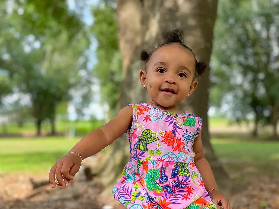 Skin, Plant, People In Nature, Tree, Smile, Leaf, Dress, Flash Photography, Happy, Grass, Pink, Baby & Toddler Clothing, Thigh, Toddler, Leisure, Baby, Human Leg, Waist, Fun, Sitting, Person, Joy