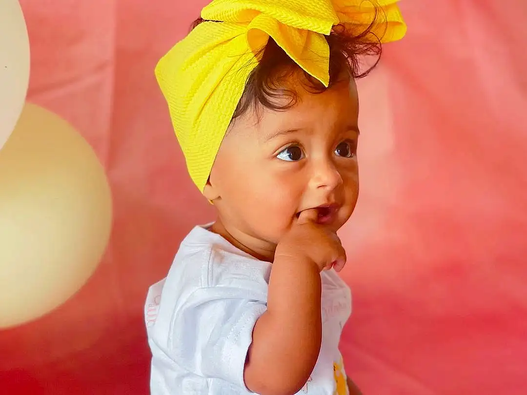 Clothing, Face, Skin, Eyes, White, Human Body, Sleeve, Baby & Toddler Clothing, Orange, Happy, Baby, Pink, People In Nature, Toddler, Petal, Beauty, Fun, Peach, Child, Magenta, Person, Headwear