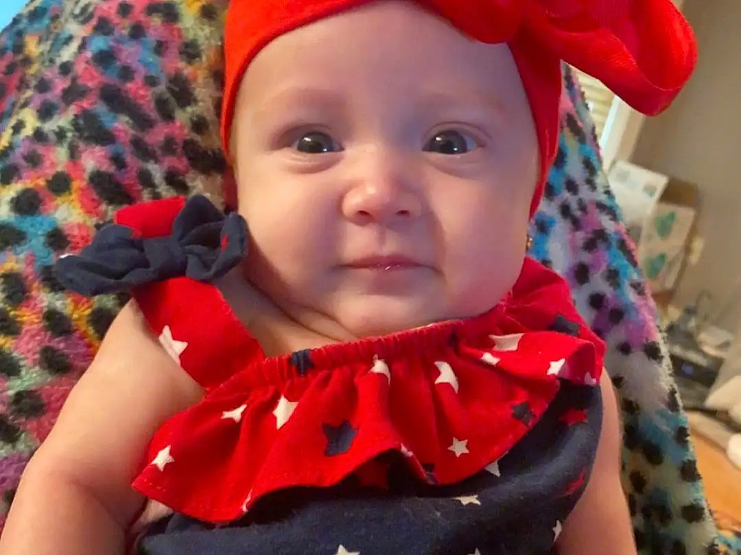 Skin, Head, Lip, Arm, Photograph, Eyes, Smile, Dress, Baby & Toddler Clothing, Neck, Textile, Sleeve, Hat, Iris, Pink, Happy, Baby, Costume Hat, Red, Headgear, Person, Headwear