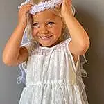 Hair, Skin, Smile, Head, Hairstyle, Shoulder, Dress, Facial Expression, One-piece Garment, White, Neck, Embellishment, Sleeve, Flash Photography, Bridal Clothing, Day Dress, Happy, Gesture, Bridal Party Dress, Pink, Person, Joy, Headwear