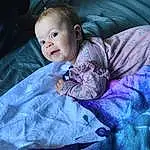 Face, Cheek, Eyes, Purple, Comfort, Smile, Sleeve, Flash Photography, Baby & Toddler Clothing, Iris, Violet, Baby, Toddler, Happy, Electric Blue, Linens, Fun, Magenta, Grass, Sitting, Person