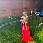 Dress, Grass, People In Nature, Shorts, Plant, Leisure, Recreation, Toddler, Outdoor Play Equipment, Outdoor Furniture, Lawn, Happy, Chute, Baby, Playground Slide, Fun, Play, Sitting, Playground, Person