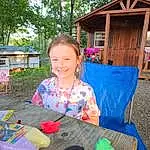Smile, Plant, Tree, Wood, Table, Tableware, Leisure, Chair, Summer, Recreation, House, Fun, Grass, Child, Toddler, Event, Outdoor Furniture, Wood Stain, Play, Soil, Person, Joy