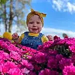 Flower, Smile, Plant, Sky, Cloud, Petal, Nature, People In Nature, Happy, Pink, Baby & Toddler Clothing, Grass, Tree, Magenta, Toddler, Flowering Plant, Leisure, Baby, Shrub, Annual Plant, Person, Joy, Headwear