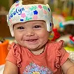 Face, Smile, Skin, Head, Photograph, Facial Expression, Happy, Yellow, Baby, Fun, Pink, Baby Playing With Toys, Toddler, Baby & Toddler Clothing, Cap, Child, Leisure, People, Person, Joy, Headwear
