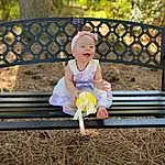 Outdoor Bench, Furniture, Plant, People In Nature, Leaf, Botany, Outdoor Furniture, Dress, Shorts, Bench, Grass, Wood, Leisure, Baby & Toddler Clothing, Happy, Toddler, Summer, Recreation, Tree, Person