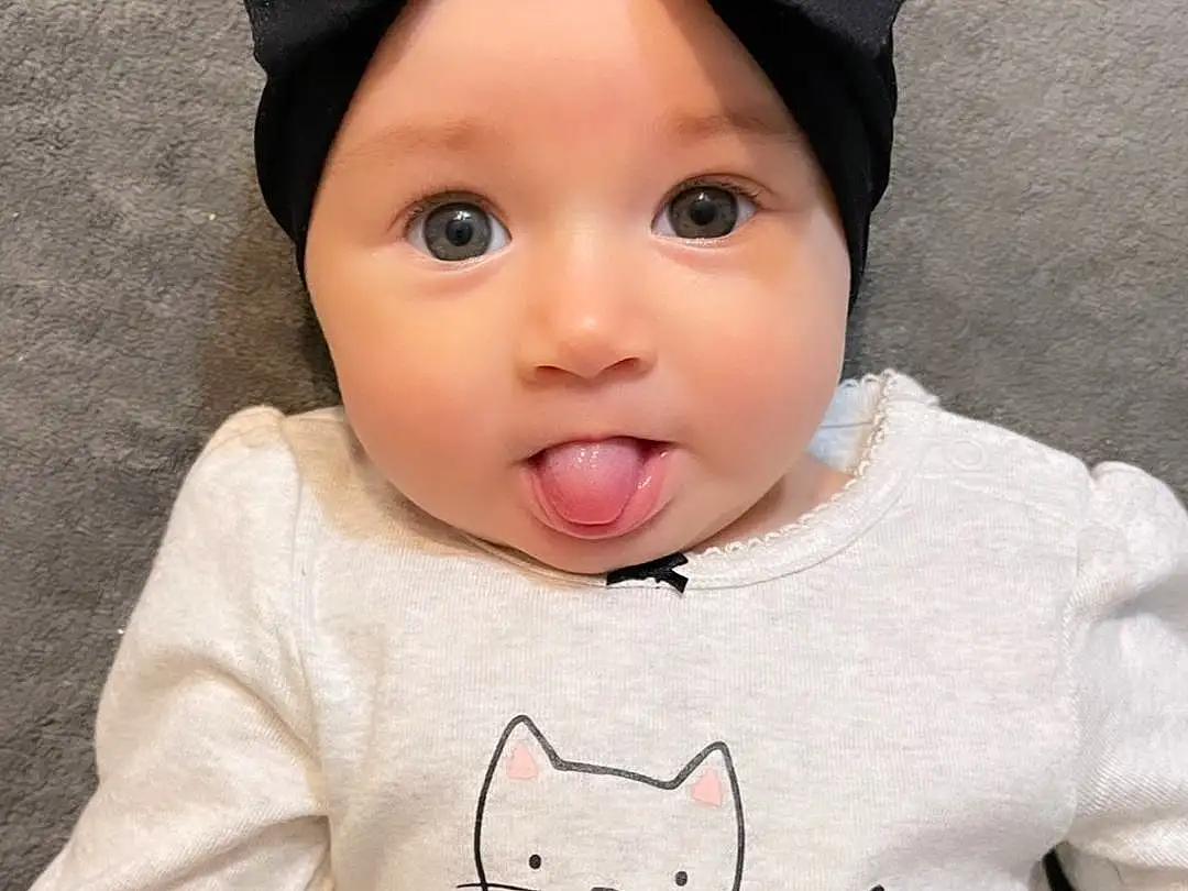 Face, Cheek, Head, Outerwear, Facial Expression, White, Black, Neck, Textile, Sleeve, Baby & Toddler Clothing, Cat, Felidae, Pink, Grey, T-shirt, Cool, Cap, Person, Surprise, Headwear