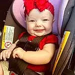 Smile, Skin, Arm, Eyes, Baby Carriage, Baby, Baby & Toddler Clothing, Happy, Toddler, Child, Car Seat, Comfort, Baby Products, Steering Wheel, Auto Part, Magenta, Costume Hat, Headpiece, Fashion Accessory, Chair, Person, Joy, Headwear