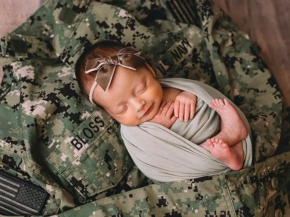 Skin, Glasses, Camouflage, Military Camouflage, Comfort, Wood, Textile, Tree, Plant, Grass, Linens, Pattern, Military Person, Marines, Military Uniform, Baby, Non-commissioned Officer, Room, Child, Soldier, Person
