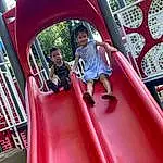 Chute, Outdoor Recreation, Pink, Playground, Playground Slide, Red, Leisure, Smile, Shorts, Public Space, Fun, Outdoor Play Equipment, Toddler, Recreation, City, Human Settlement, Baby & Toddler Clothing, Magenta, Child, T-shirt, Person, Joy