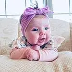 Cheek, Smile, Eyes, Comfort, Baby & Toddler Clothing, Purple, Happy, Pink, Baby, Toddler, Linens, Grass, Fashion Accessory, Fun, Hair Accessory, Magenta, Headpiece, Room, Headband, Baby Products, Person