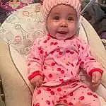 Face, Cheek, Skin, Smile, Outerwear, Arm, Facial Expression, Comfort, Cap, Baby & Toddler Clothing, Textile, Baby, Sleeve, Happy, Pink, Dress, Toddler, Headgear, Cool, Magenta, Person, Headwear