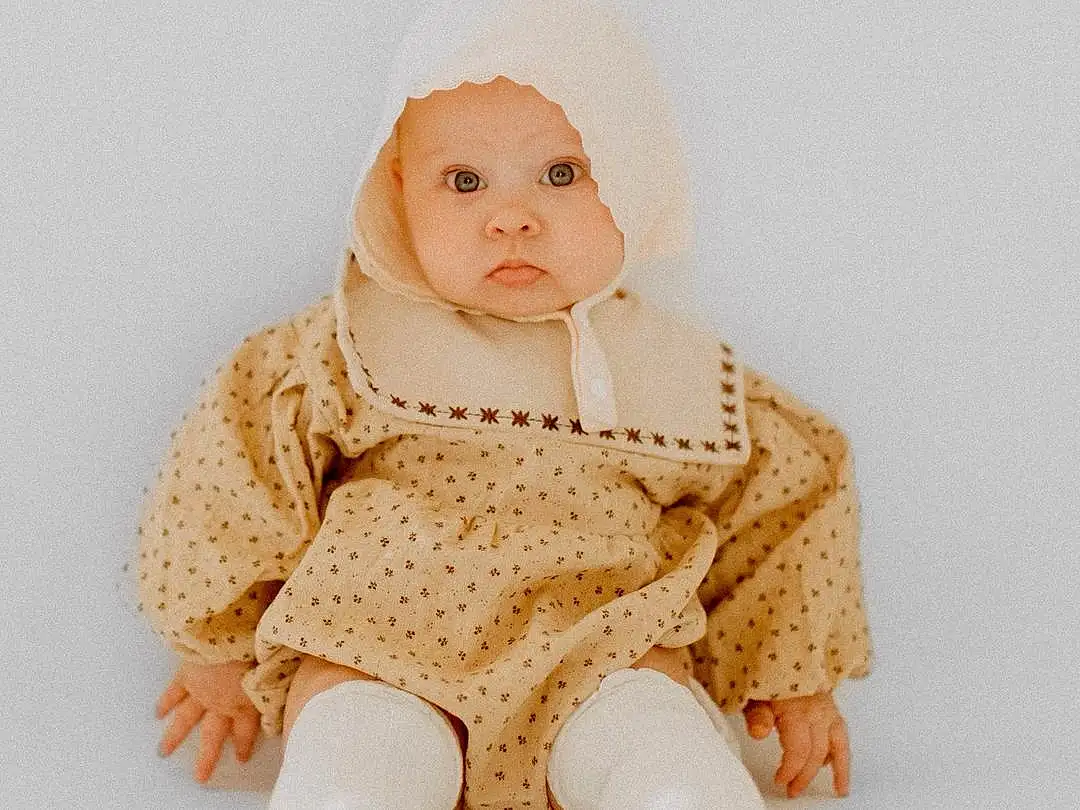 Eyes, Baby & Toddler Clothing, Sleeve, Headgear, Beige, Baby, Collar, Art, Cap, Wool, Woolen, Pattern, Peach, Sitting, Furry friends, Fashion Accessory, Baby Products, Child, Toy, Baby Toys, Person, Headwear