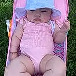 Skin, Hand, Arm, Plant, Human Body, Textile, Baby & Toddler Clothing, Pink, Thigh, Grass, Finger, Hat, Headgear, Happy, Sun Hat, Baby, Toddler, Summer, Chest, Leisure, Person, Headwear
