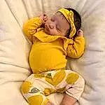 Face, Arm, Leg, Comfort, Baby & Toddler Clothing, Textile, Sleeve, Yellow, Orange, Stomach, Baby, Toddler, Thigh, Happy, Child, Baby Sleeping, Linens, Barefoot, Foot, Abdomen, Person