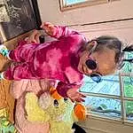 Window, Textile, Pink, Fun, Toddler, Child, Plant, Sunglasses, Room, Toy, Magenta, Eyewear, Stuffed Toy, Happy, Furry friends, Play, Leisure, Person