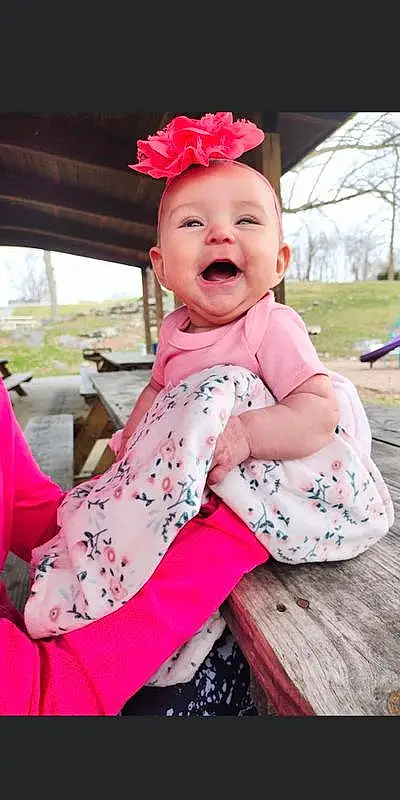 Skin, Smile, Sleeve, Baby & Toddler Clothing, Pink, Happy, Fun, Leisure, Toddler, Grass, Magenta, Baby, Child, Recreation, Pattern, Sitting, Baby Products, Peach, Fashion Accessory, Vacation, Person