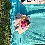 Water, Green, Plant, Recreation, Happy, Leisure, People In Nature, Sunglasses, Grass, Petal, Magenta, Linens, Fun, Flower, Play, Inflatable, Toddler, Child, Visual Arts, Sitting, Person