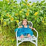 Plant, Smile, Cloud, Flower, People In Nature, Sky, Happy, Agriculture, Outdoor Furniture, Grass, Leisure, Flowering Plant, Meadow, Chair, Grassland, Field, Comfort, Plantation, Prairie, Shrub, Person, Joy