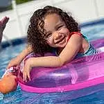 Water, Smile, Facial Expression, Happy, Outdoor Recreation, Body Of Water, Baby Float, Pink, Leisure, Toddler, Recreation, Fun, Bathing, Child, Inflatable, Magenta, Baby, Nonbuilding Structure, Boats And Boating--equipment And Supplies, Play, Person, Joy