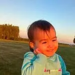 Face, Smile, Sky, Chin, Hairstyle, Daytime, Cloud, People In Nature, Plant, Happy, Sunlight, Gesture, Finger, Baby & Toddler Clothing, Tree, Toddler, Cool, Leisure, Travel, Grass, Person, Joy