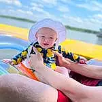 Cloud, Water, Sky, Blue, Happy, Body Of Water, Outdoor Recreation, Leisure, Baby, Toddler, Finger, Baby & Toddler Clothing, Headgear, Aqua, Recreation, Boats And Boating--equipment And Supplies, Thigh, Personal Protective Equipment, Fun, Person, Headwear