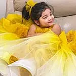 Face, Hair, Head, Furniture, Arm, Eyes, White, Couch, Comfort, Textile, Fashion, Yellow, Happy, Flash Photography, Dress, Black Hair, Linens, Child, Bedding, Leisure, Person, Joy