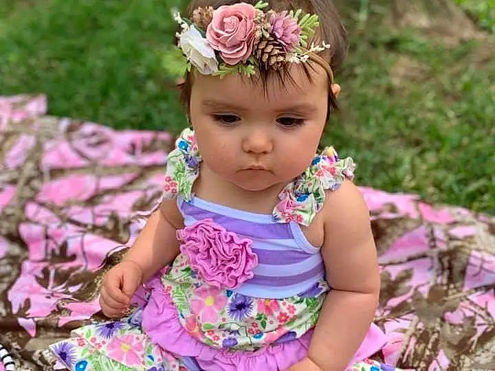Clothing, Face, Skin, Head, Plant, Eyes, Dress, Flower, Leaf, Baby & Toddler Clothing, Purple, Botany, Sleeve, Happy, Pink, Grass, People In Nature, Day Dress, Toddler, Magenta, Person, Headwear