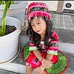 Clothing, Photograph, White, Green, Plant, Flowerpot, Sleeve, Happy, Pink, Headgear, Grass, Dress, Waist, Cool, Thigh, Red, Black Hair, Personal Protective Equipment, Magenta, Toddler, Person, Headwear