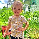 Plant, Shirt, Arm, Shorts, Sky, Cloud, Green, Smile, Botany, People In Nature, Leaf, Sleeve, Flowerpot, Grass, Baby & Toddler Clothing, Houseplant, Toddler, Happy, Summer, Waist, Person, Joy