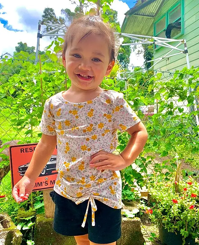Plant, Shirt, Arm, Shorts, Sky, Cloud, Green, Smile, Botany, People In Nature, Leaf, Sleeve, Flowerpot, Grass, Baby & Toddler Clothing, Houseplant, Toddler, Happy, Summer, Waist, Person, Joy