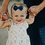 Face, Skin, Head, Smile, Hand, Hairstyle, Shoulder, Azure, One-piece Garment, Baby & Toddler Clothing, Textile, Sleeve, Happy, Standing, Dress, Gesture, Finger, Baby, Pink, Person, Joy, Headwear