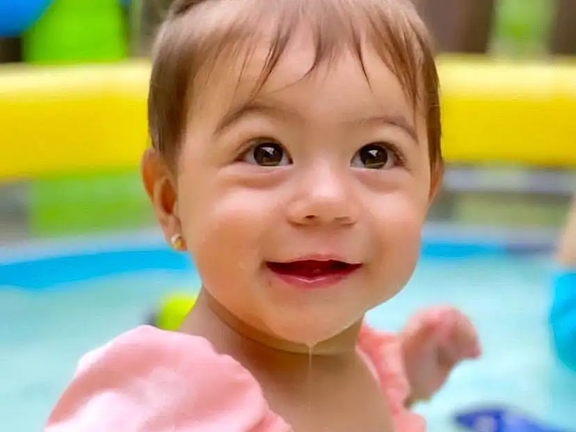 Skin, Smile, Water, Hairstyle, Facial Expression, White, Happy, Swimming Pool, Toddler, Baby Playing With Toys, Baby & Toddler Clothing, Leisure, Baby, Fun, Recreation, Child, Bathing, Play, Person, Joy
