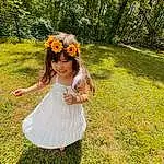 Flower, Plant, People In Nature, Smile, Happy, Grass, Sunlight, Baby & Toddler Clothing, Tree, Toddler, Grassland, Headpiece, Meadow, Day Dress, Fun, Lawn, Petal, Headband, Child, Person, Joy